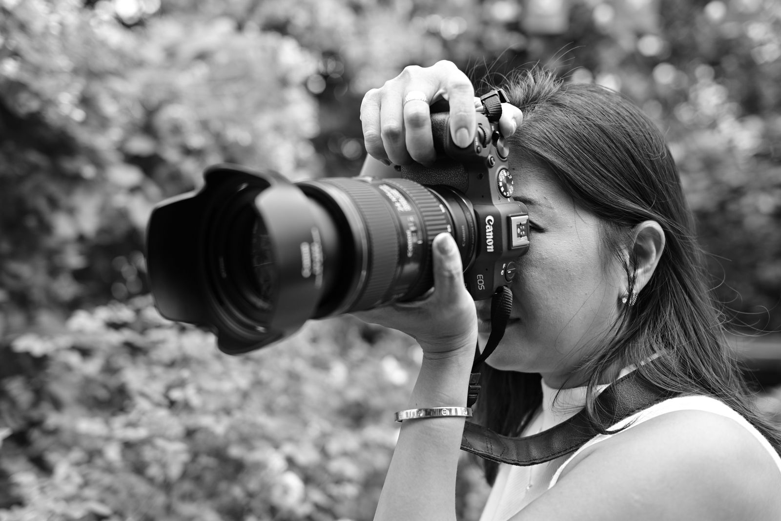 Female photographer capturing nature with a DSLR camera